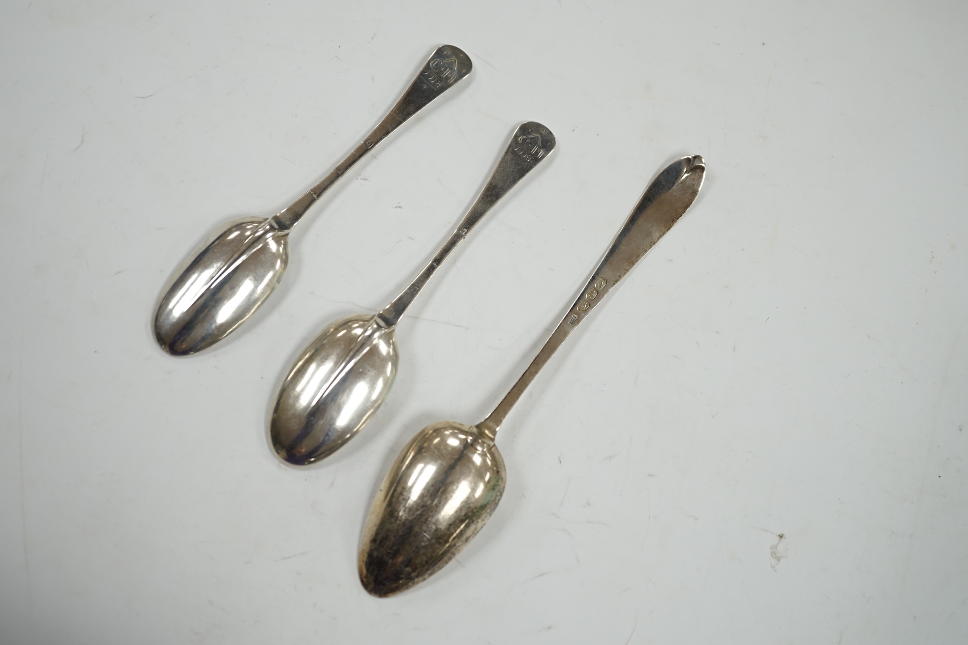 A pair of early 18th century English? provincial silver Hanovarian rat tail table spoons, three stamps WS,WS & SB? only, 19.4cm, together with a George III Irish bright cut engraved silver table spoon, J. Brady, Dublin,